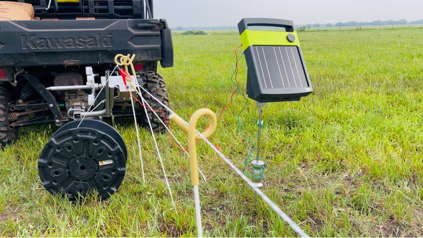 Solar fence chargers and power reel in use