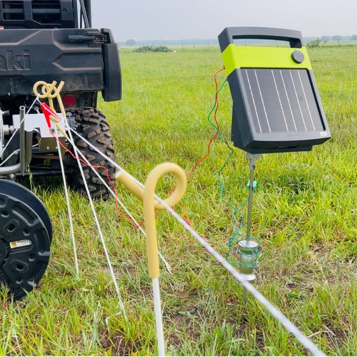 Solar fence chargers and power reel in use