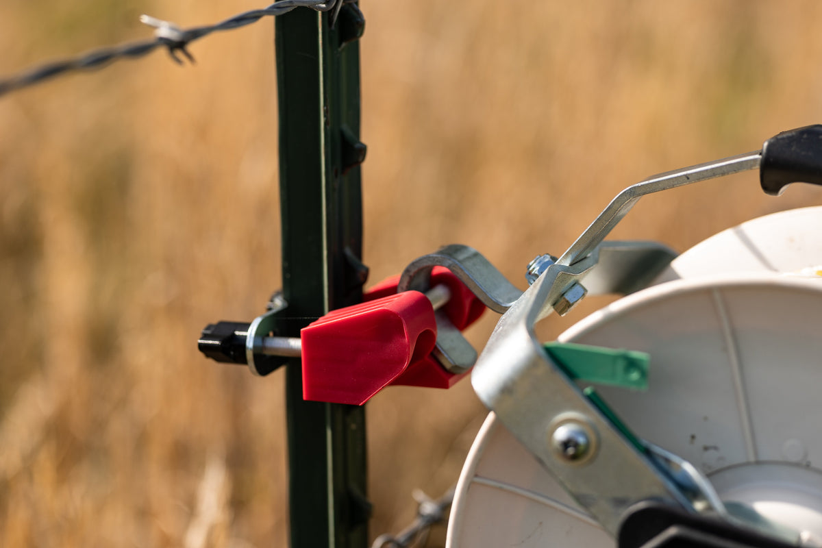 Utilizer red poly wire reel holder with a reel for electric fence