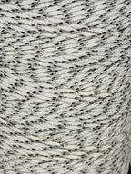 Close-up of a spool of gray and white yarn