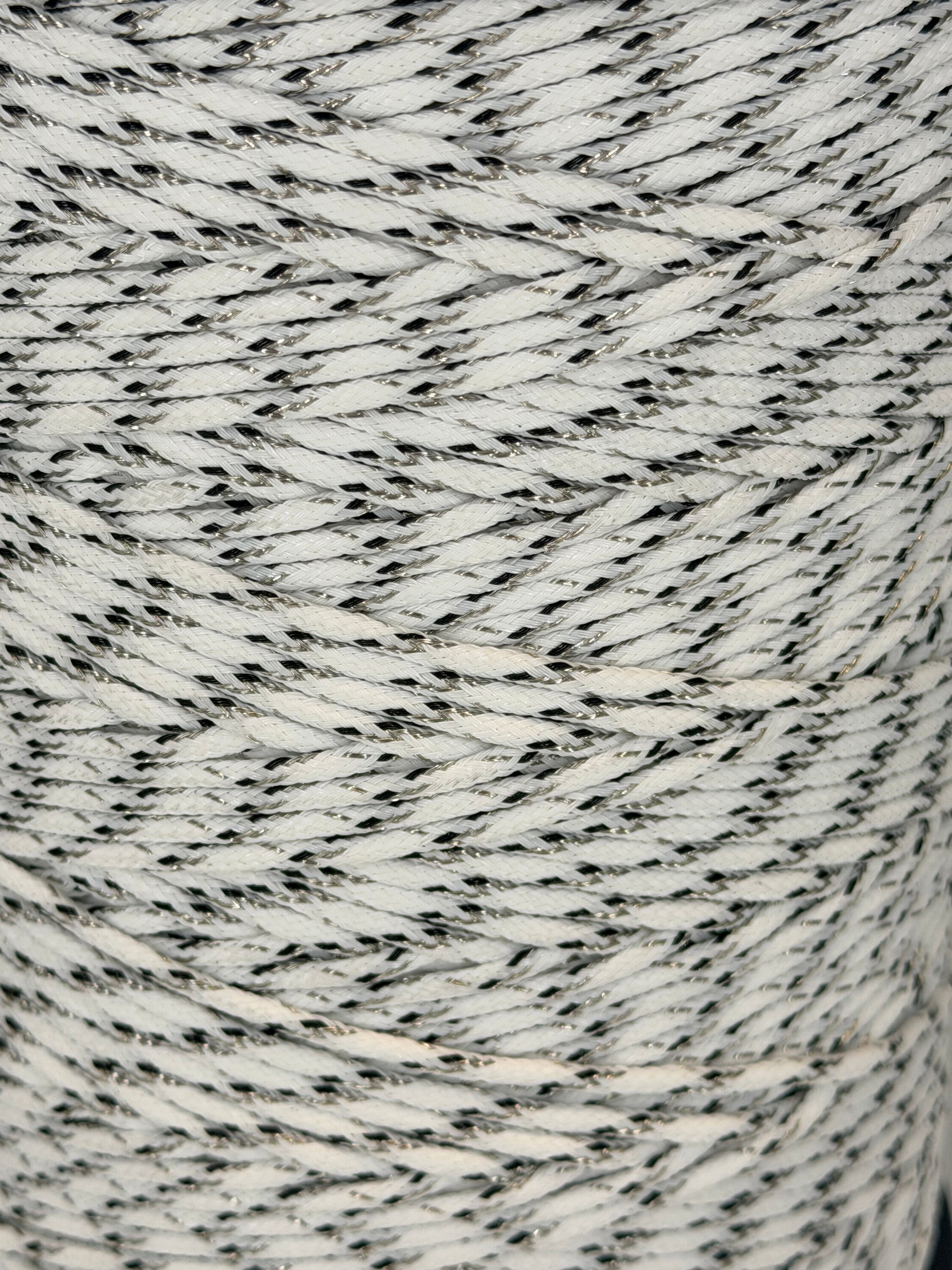 Close-up of a spool of gray and white yarn