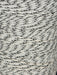 Close-up of a spool of gray and white yarn